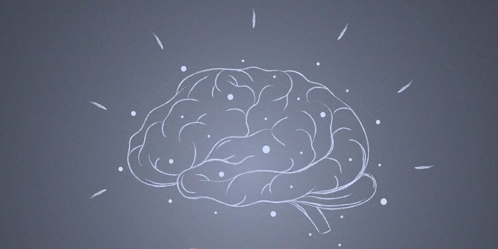 Neuromarketing - ilustração com o fundo cinza e, em destaque, no centro o desenho de um cérebro na cor branca.